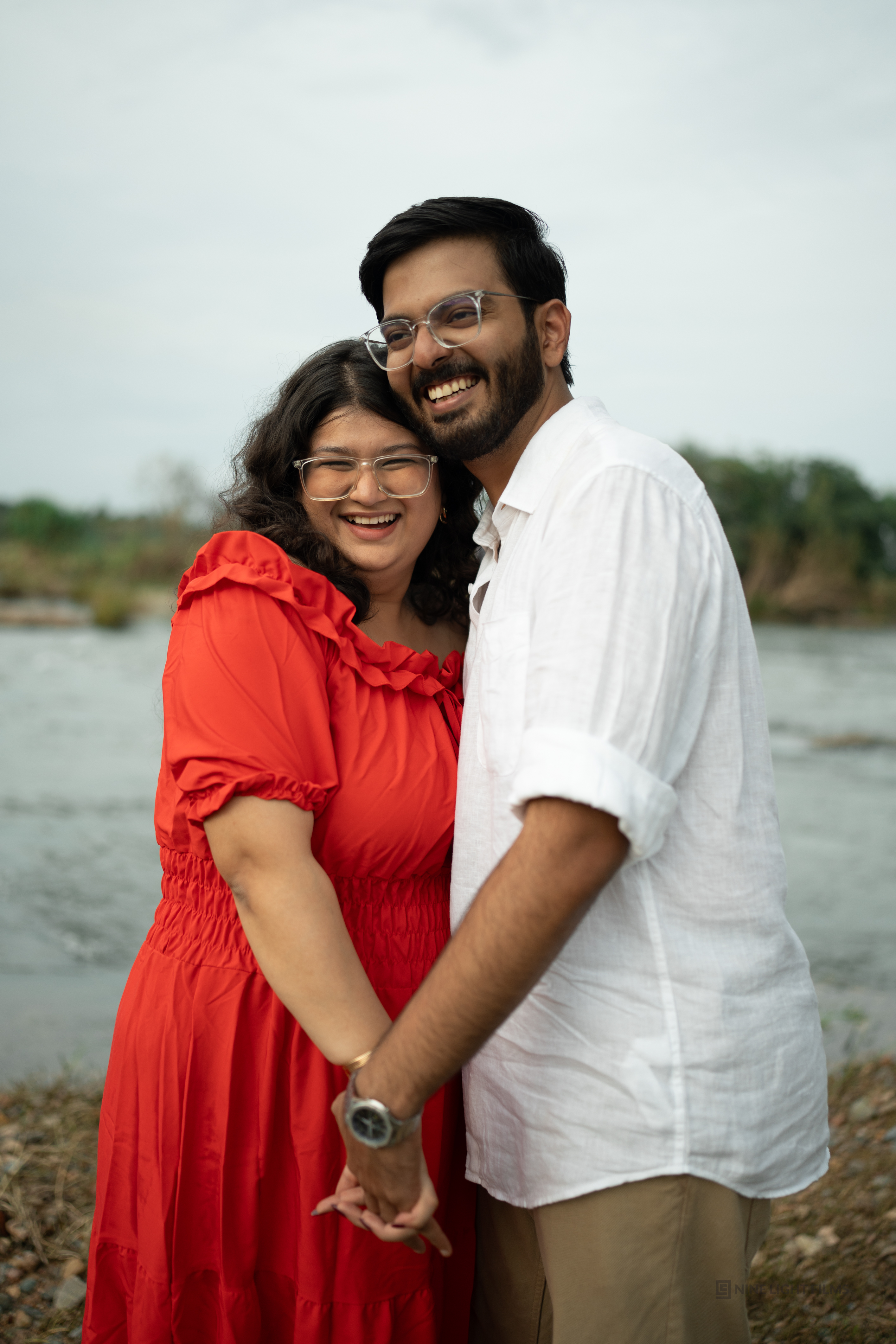 Couple embracing by the river.